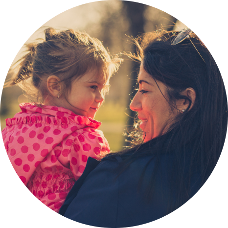 a woman holding a child and smiling